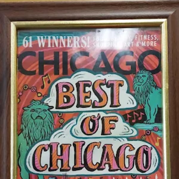 Framed "Best of Chicago" award with two green lions and musical notes on a red background.