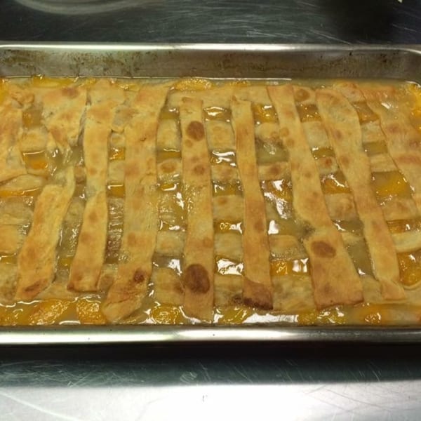 A large pan of Chef Daddy's southern peach cobbler with a lattice crust.